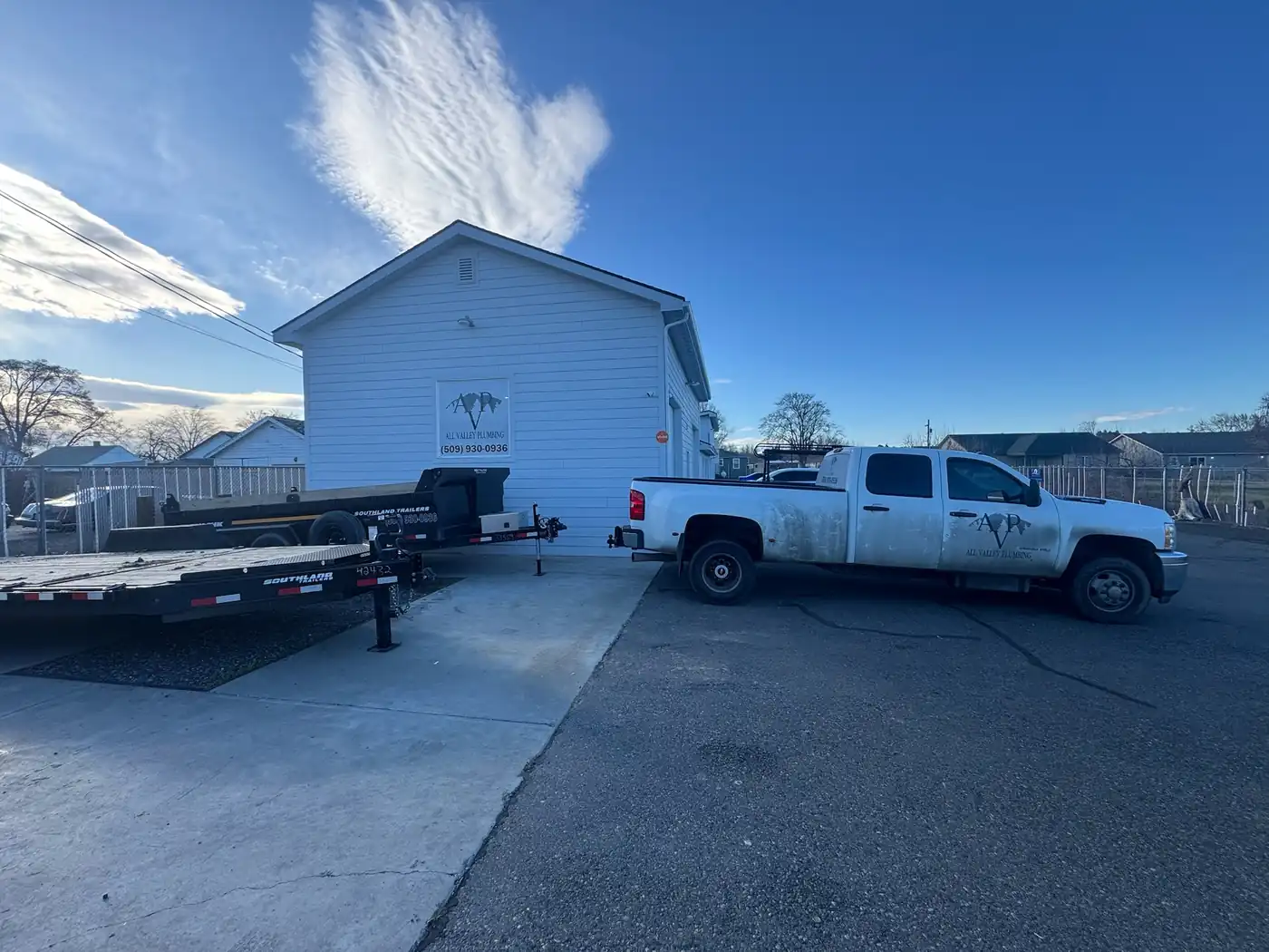 The All Valley Plumbing shop on Fruitvale Blvd with the AVP mountain sign and the equipment trailer