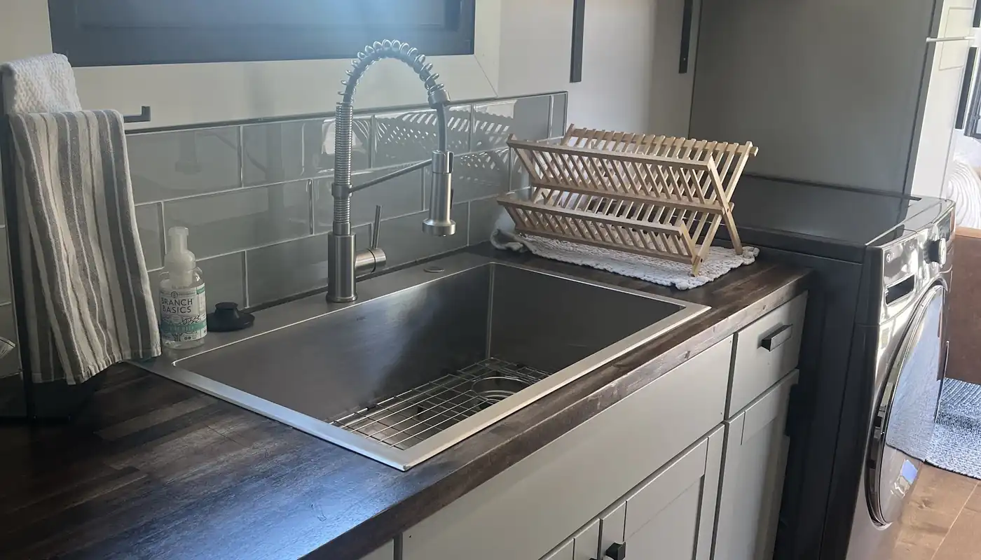 A stainless sink and pull-down faucet installed by All Valley in a laundry-room remodel